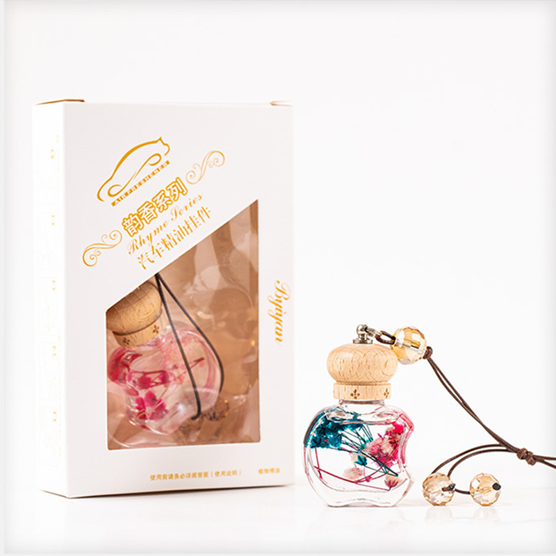 A black circular liquid air freshener with a dial to control fragrance intensity.