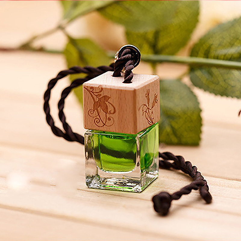 A simple glass bottle containing a clear, plant-based liquid perfume.