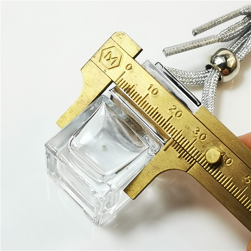 A red felt air freshener die-cut into a star shape with a brand logo.