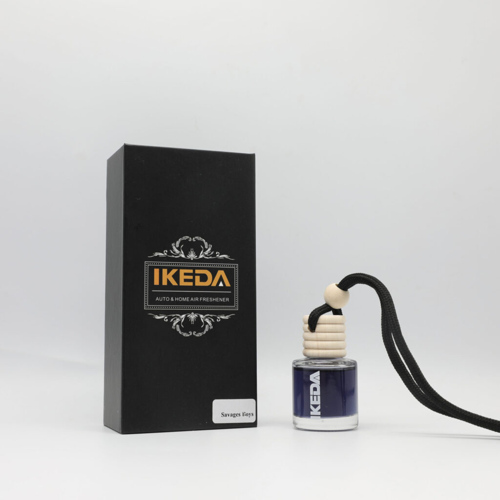 A white ceramic car pendant with a custom logo engraving, hanging from a rearview mirror.