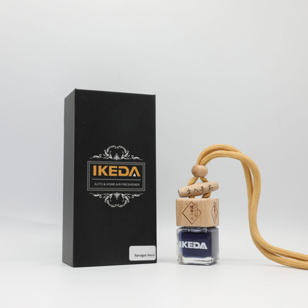 A white plastic, refillable air freshener clip attached to a car's air vent.